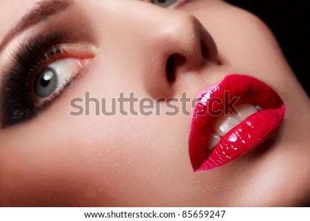 Close-up portrait of sexy young model with glamour red lips make-up