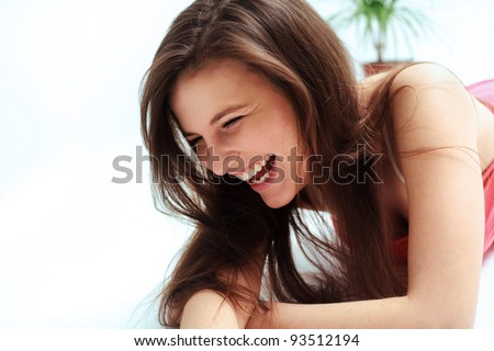 Happy woman laughing against white background