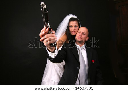 newly-married couple with gun