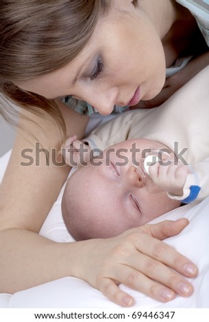 Closeup faces of happy mother with cute newborn baby