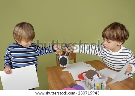 Child, kid engaged in arts and crafts activity, sharing and playing nice together