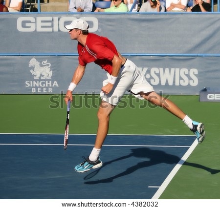 Unique shot of John Isner, a rising pro tennis star, completing a serve at Leggmason 2007. It was his first big pro tournament where he got defeated in the final by Andy Roddick.