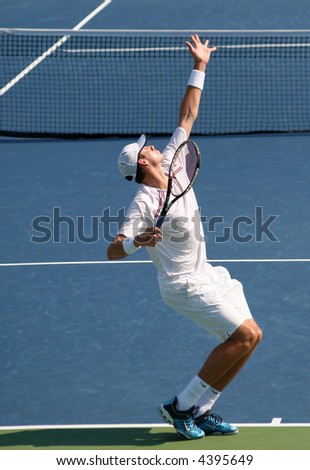 Unique shot of John Isner, a rising American pro tennis star, completing a serve at Leggmason 2007. It was his first big pro tournament where he got defeated in the final by Andy Roddick.