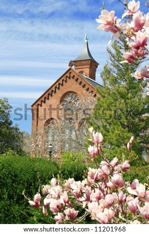 Scenic view of the Smithsonian Castle, landmark on the Mall, Washington DC, view from the garden through cherry blossoms