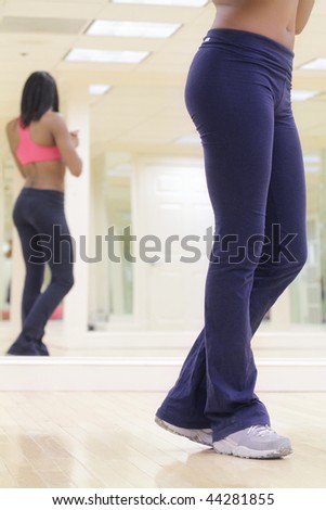 Legs of a female fitness instructor in her studio or gym, fitness theme