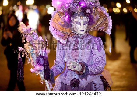 VENICE, ITALY - FEBRUARY 16: Unidentified person in Venice mask at St. Mark\'s Square, Carnival of Venice on February 16, 2012. Annual carnival was held in 2012 from February 11 to February 21, 2012.