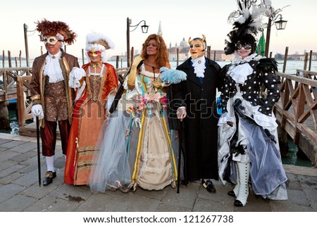 VENICE, ITALY - FEBRUARY 17: Unidentified persons in Venice mask at St. Mark\'s Square, Carnival of Venice on February 17, 2012. Annual carnival was held in 2012 from February 11 to February 21, 2012.