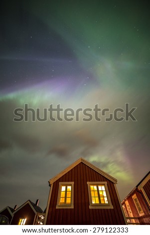 Aurora borealis above rorbuer in Hamnoy village, Moskenesoy island, Lofoten islands, Norway