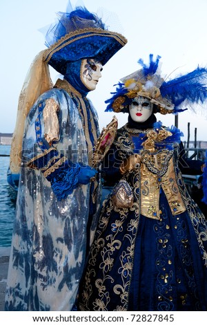 VENICE, ITALY - FEB 26: Woman and man in carnival costume pose at Venice carnival on Feb 26, 2011 in Venice. Venice is one of the world\'s top places to celebrate carnival.