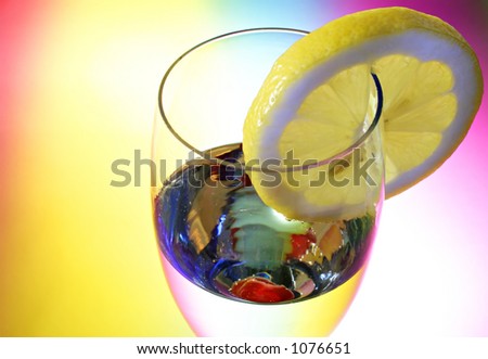 Glass of champagne with a cherry and a lemon