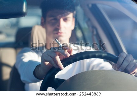 Similar – Image, Stock Photo Adult man smoking while looking at camera during sunset