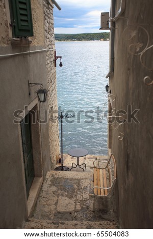 a view at the sea through a narrow passage