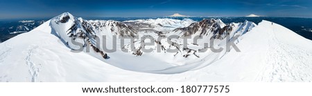Summit view of the Mount St. Helens caldera. Mount Rainier, Mount Adams, and the Olympic Mountains in view.