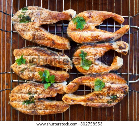 succulent salmon steaks cooked on fire