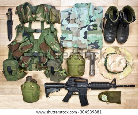 set of military equipment of the Vietnam War era on the wooden background