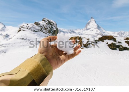 Snow on left hand with the background of Matterhorn, Switzerland. First-person view.
