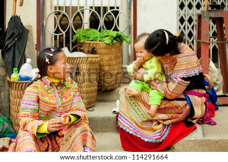 SAPA,VIETNAM - FEB 28: Unidentified girl of the H\'mong Ethnic Minority carries baby on February 28, 2010 in Sapa, Vietnam. H\'mong ethnic minority in Vietnam have a population just under 600,000.