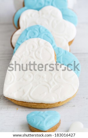 Shortbread cookies in the shape of heart decorated with sugar paste