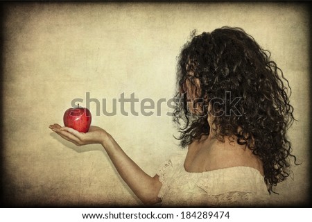 Portrait of woman in white dress holding a red apple in her hands, textured back