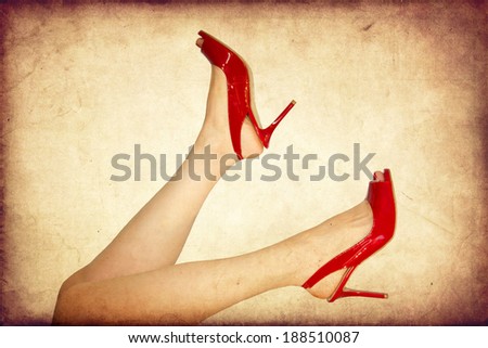 Perfect female legs wearing high heels isolated on white background