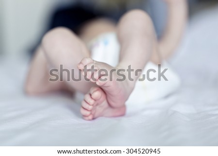 Close up picture of new born baby feet on a white sheet