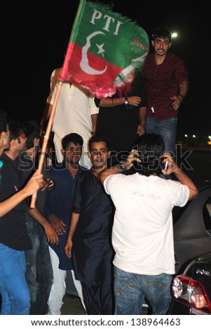 KARACHI, PAKISTAN: MAY 10: Pakistan Tehreek-e-Insaf (PTI) party supporters on the streets of Karachi, Pakistan on May 10, 2013. Pakistan\'s national elections took place on May 11, 2013.