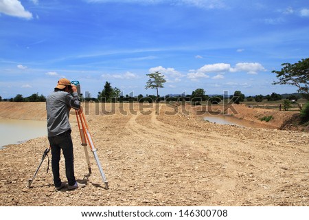 Land surveyors using camera on construction site