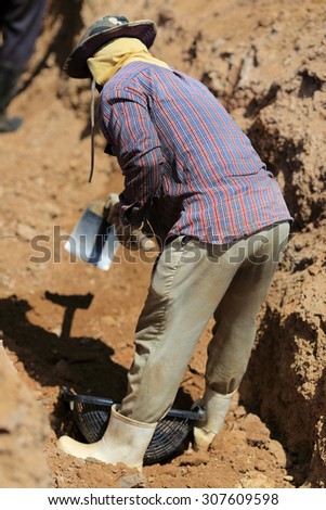 Building worker digging on construction site