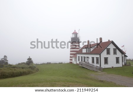 WEST QUODDY HEAD LIGHTHOUSE, MAINE, USA - August 10: Dense fog covering most easter continental lighthouse in USA, West Quoddy Head Lighthouse, August 10, 2014