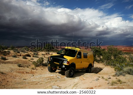 Yellow 4x4 van off road during storm in Utah