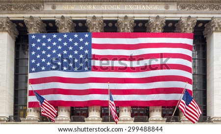 New York, NY - JULY 2015 - The New York Stock Exchange draped with a large American flag on Wall Street in New York City on July 19, 2015.