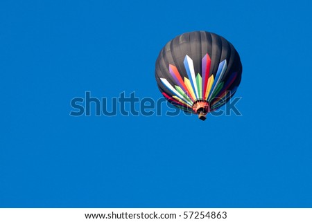 Colorful Hot Air Balloon Isolated on Clear Blue Sky