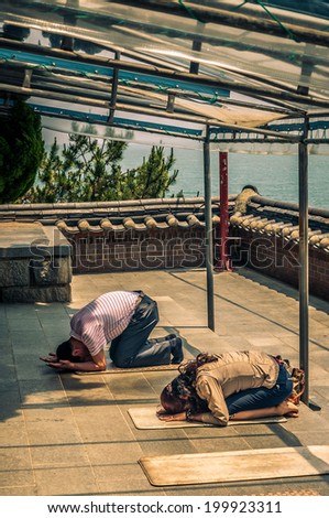 BUSAN, SOUTH KOREA - JUNE 7: Buddhists pray at Haedong Yonggungsa Temple on June 7, 2014 in Busan, South Korea.
