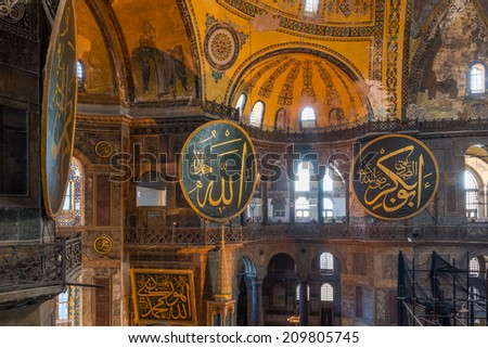 ISTANBUL, TURKEY - JULY 29: Large Islamic roundels hang from the walls of the Hagia Sophia. Photo taken July 29, 2014 in Istanbul, Turkey.