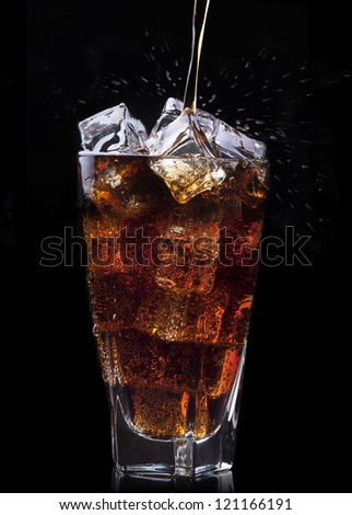 Fresh cola drink background with ice and splash on a black