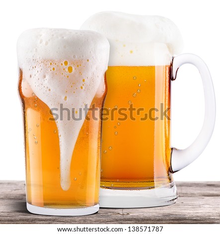 Frosty fresh beer with foam isolated on a vintage wooden table
