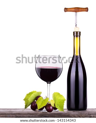 Ripe grapes, wine glass and bottle of wine isolated on white