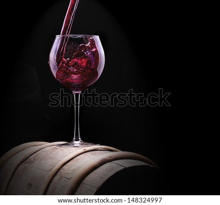 Elegant red wine glass  in black background
