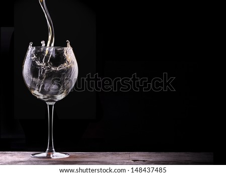 Elegant white wine glass  in black background