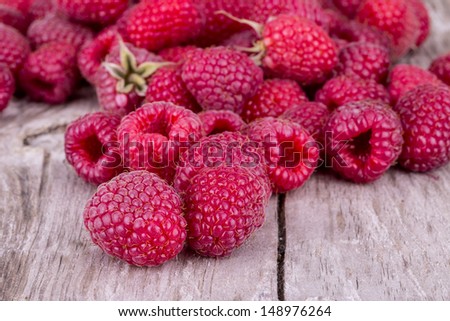 Sweet raspberry on wooden table tasty food background