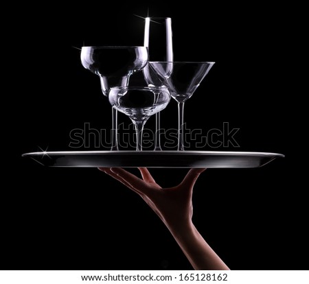 tray with different empty stemware on black background - champagne, beer, cocktail, wine, brandy, whiskey, scotch, vodka, cognac