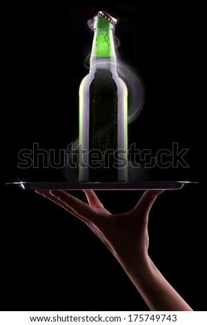 waiter hand with open wet beer bottles on a tray