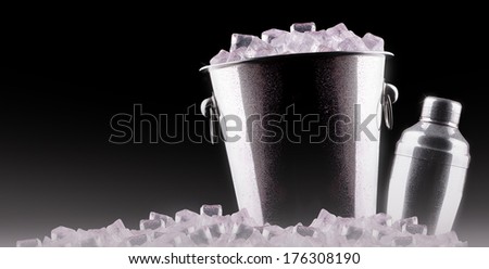 Cocktail shaker with metal ice bucket isolated against a black background