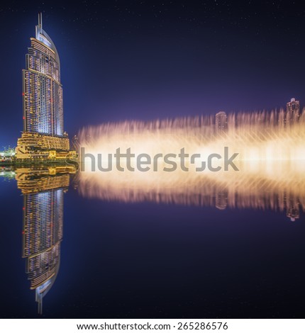 DUBAI, UAE - NOVEMBER 25, 2014: The Dancing Fountain of Dubai performs to the beat of the selected music at dusk near Burj Khalifa and  Dubai Mall in downtown of Dubai. Located on Sheikh Zayed Road.