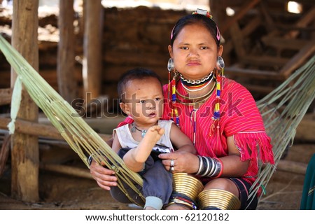 MAE HONG SON, THAILAND - APRIL 16: old woman and son of the big-ear Karen tribe sitting to be watched by tourists April 16, 2010 Mae Hong Son, Thailand