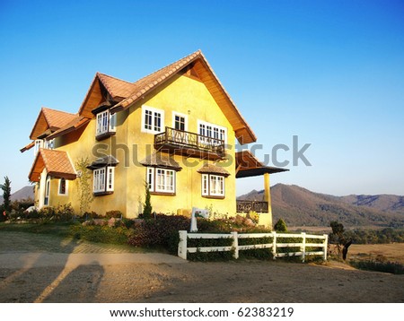 house on hill with blue sky.