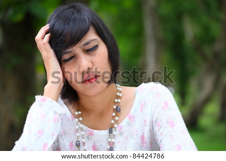 female head ache with  nice green background