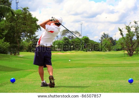 man swing golf in nice golf course.