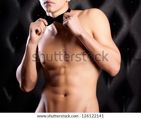 beautiful naked guy in a hat and bow tie