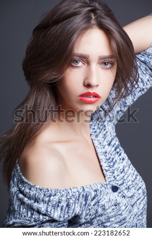 Fashion portrait of beautiful woman in knitted sweater